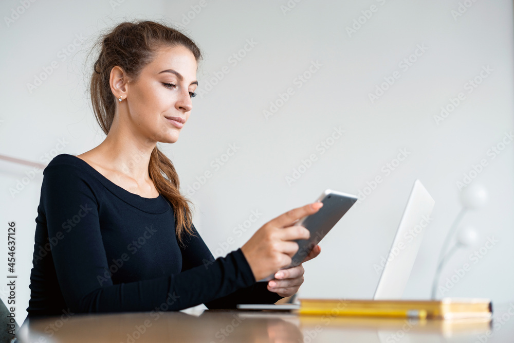 Female student online training. A freelancer works on a tablet in a coworking space. A blogger is surfing in a search engine on the Internet. Ordering a shopping product on the store's website. Female student online training. A freelancer works on a tablet in a coworking space. A blogger is surfing in a search engine on the Internet. Ordering a shopping product on the store's website.