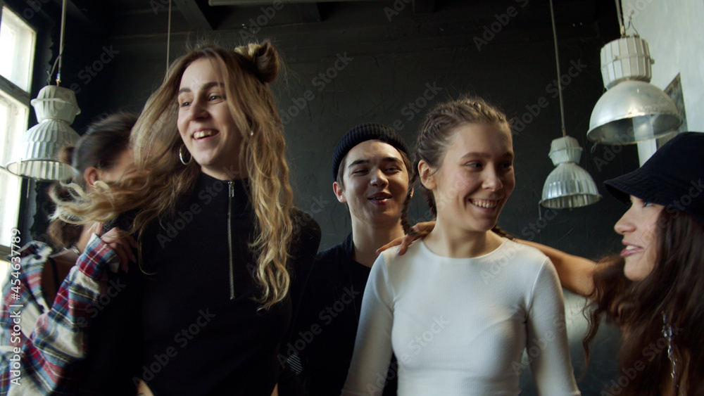 Group of dancers came to a rehearsal in a fashionable studio in dark colors