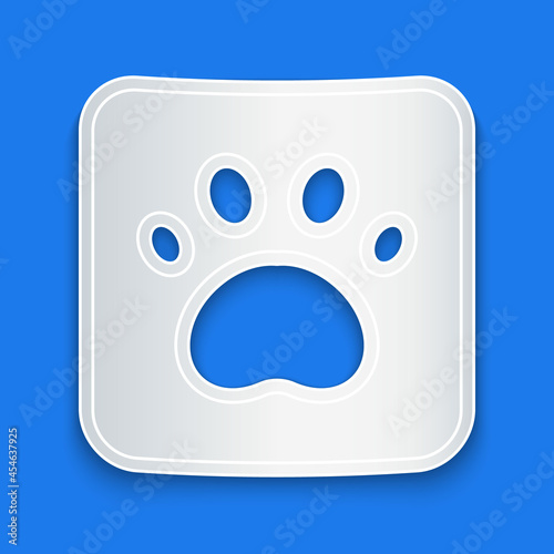 Paper cut Paw print icon isolated on blue background. Dog or cat paw print. Animal track. Paper art style. Vector