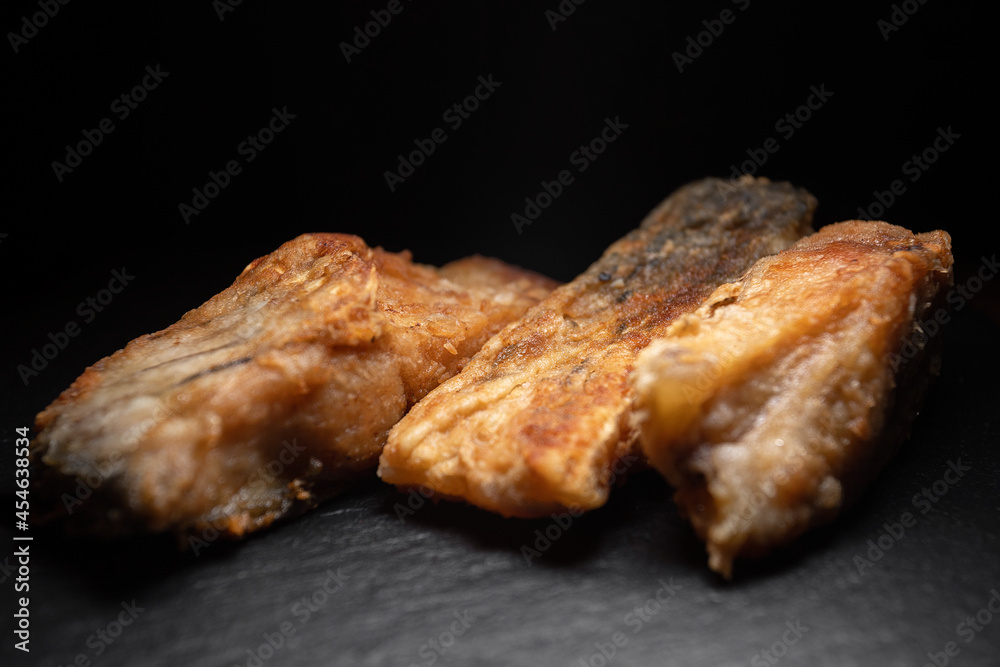 Three fried carp fish on a black background Three fried carp fish on a black background