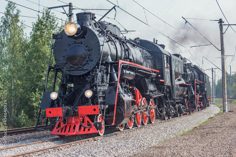 Naklejka premium Steam retro train departs from the station.