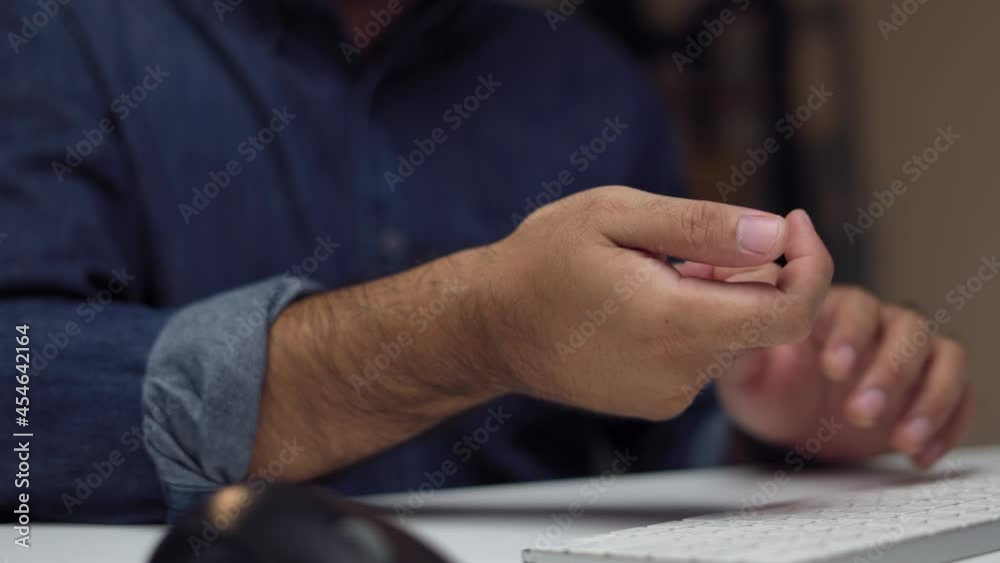Close up hand man texting on keyboard laptop work so hard and long time that he has office