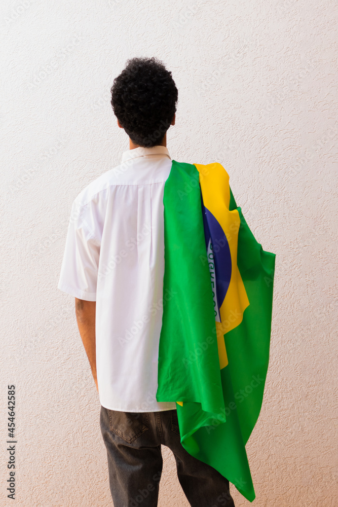 Business or Worker Holding a Brazil Flag Isolated On White. Flag and Independence Day Concept Image. Business or Worker Holding a Brazil Flag Isolated On White. Flag and Independence Day Concept Image.