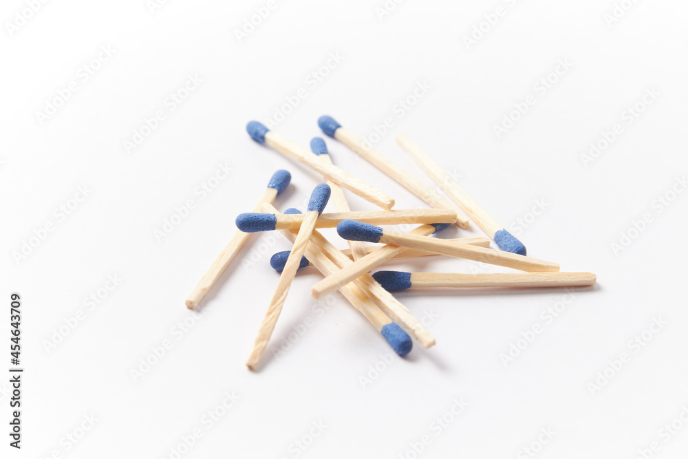 Matches on a white background, pile of phosphorus blue head matchsticks isolated. Used for a barbecue ignite or kitchen household