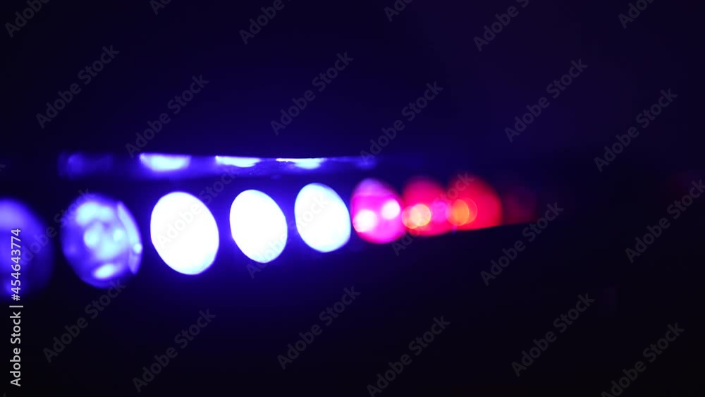 Lens flares from a police car flashers. Red and blue light flash