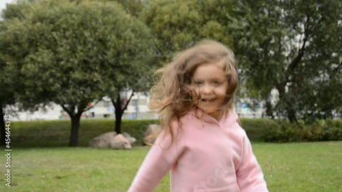 Wallpaper Mural happy little girl jumping and rejoicing in the park on the grass Torontodigital.ca