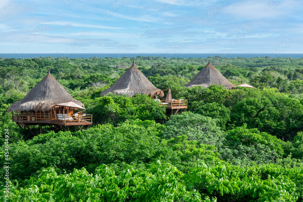 Aerial panoramic view of a bungalow nature village in the middle of the forest. Aerial panoramic view of a bungalow nature village in the middle of the forest.