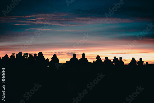 Group of people watching the sunrise over the Sydney Harbour Bridge
