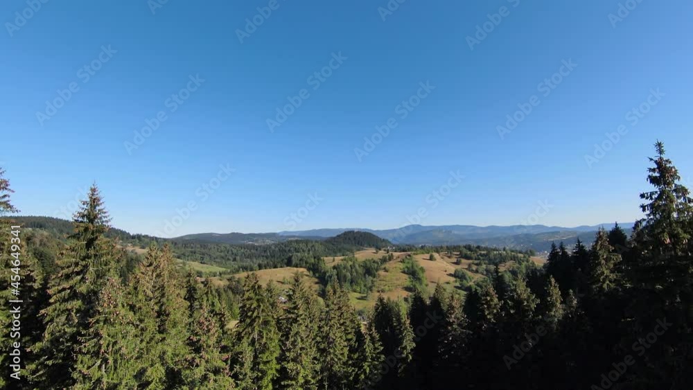 Extreme close flight over treetops in the misty forest morning. Aerial shot on fpv sport drone over clouds nature valley landscape with mountain hilly terrain. Dynamic cinematic view. Extreme close flight over treetops in the misty forest morning. Aerial shot on fpv sport drone over clouds nature valley landscape with mountain hilly terrain. Dynamic cinematic view.
