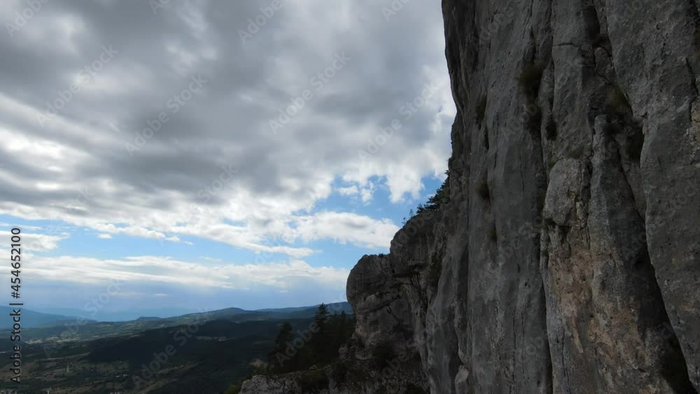 Aerial cinematic shot high speed sport fpv drone flying over natural mountain cliff surrounded Amazing nature rocky terrain with green vegetation and forest on cloudy day. Aerial cinematic shot high speed sport fpv drone flying over natural mountain cliff surrounded Amazing nature rocky terrain with green vegetation and forest on cloudy day.