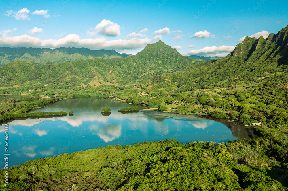 Aerial view of the ancient Moli'i fishponds with reflections of the Koolau mountains in the ponds. The ponds are located near Kaneohe, on the island of Oahu, Hawaii, USA.