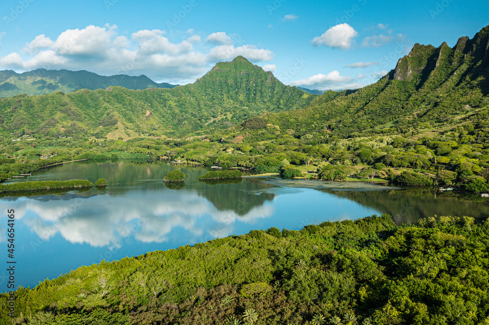 Aerial view of the ancient Moli'i fishponds with reflections of the Koolau mountains in the ponds. The ponds are located near Kaneohe, on the island of Oahu, Hawaii, USA.