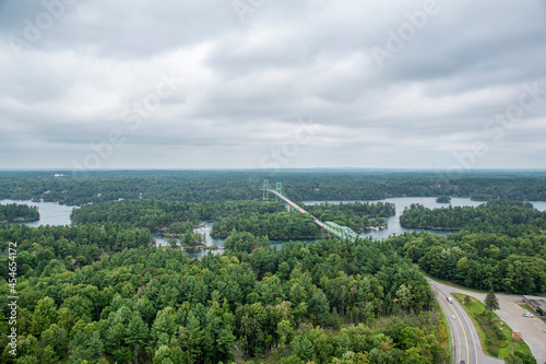 An aerial view of 1000 Islands National Park showing the bridge leading from the mainland onto Hill Island as well as the St. Lawrence River on a gloomy day. photo