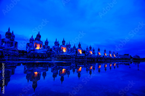 Face of Buddha statue,Many ancient Buddha images reflected by water,Ancient Thai Architecture.