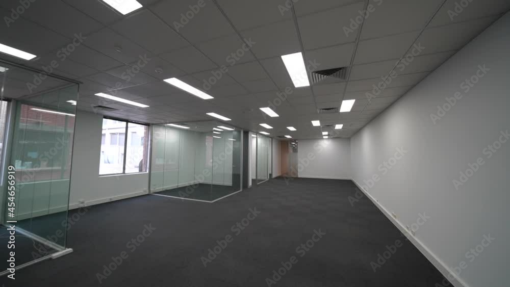 Empty bright space with windows to city skyline of modern office, dolly forward