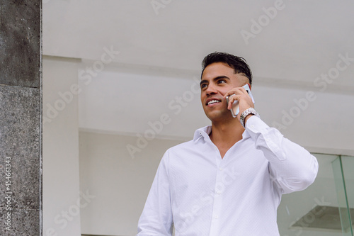 Businessman talking on the phone, business concept, white shirt, modern haircut