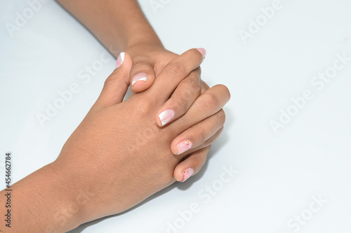 Intertwined fingers of a young woman, close-up.Concept wait