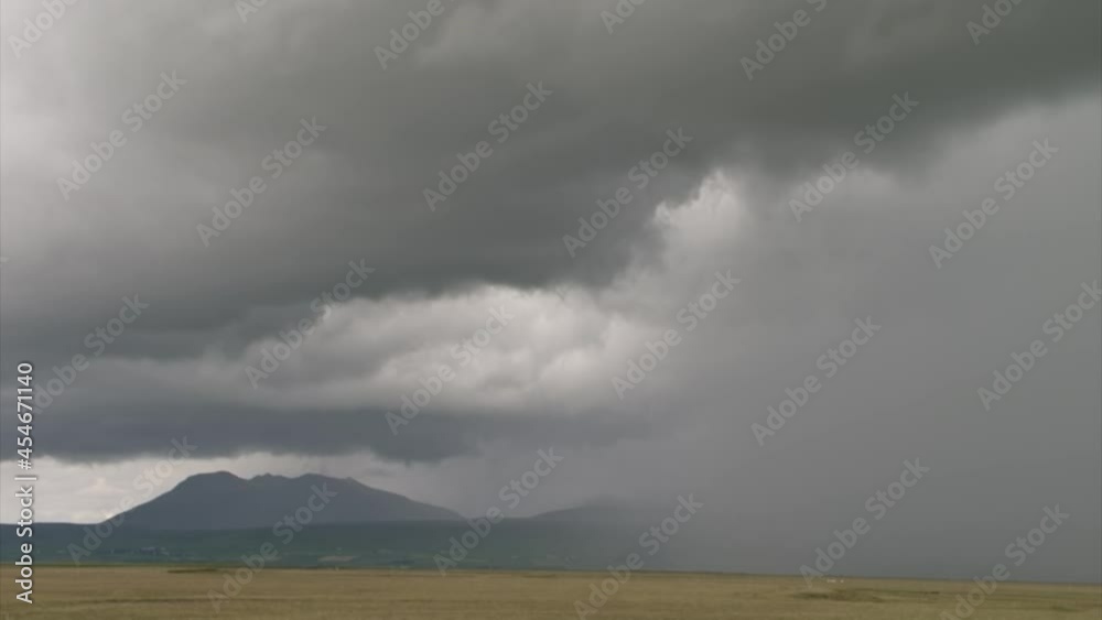 time lapse of clouds and rain over a hilly landscape without trees in Iceland time lapse of clouds and rain over a hilly landscape without trees in Iceland