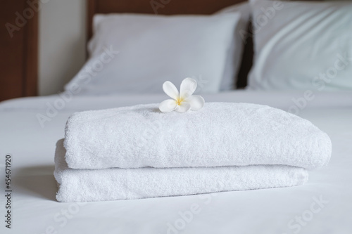 Plumeria and towels on the bed in the luxury hotel room ready for tourist travel