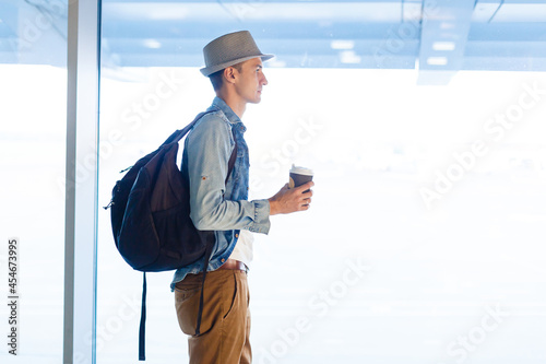 Young male passenger at the airport waiting for her flight