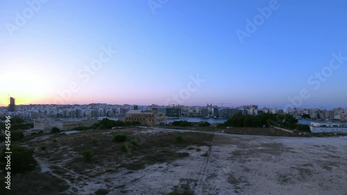 Malta, turning timelapse video from Manoel Island, showing Sliema, Ta' Xbiex and Valletta cities during sunset. photo