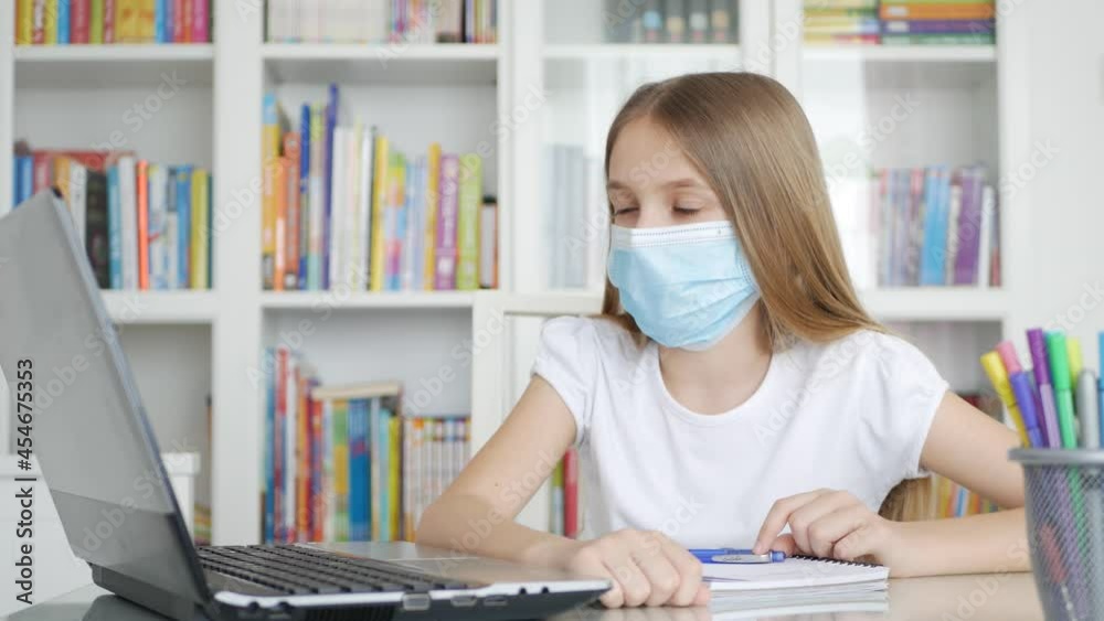 Kid Using Laptop Studying, Child Learning, Writing at Home, Schoolgirl in Coronavirus Pandemic, Homeschooling, Online Education Kid Using Laptop Studying, Child Learning, Writing at Home, Schoolgirl in Coronavirus Pandemic, Homeschooling, Online Education