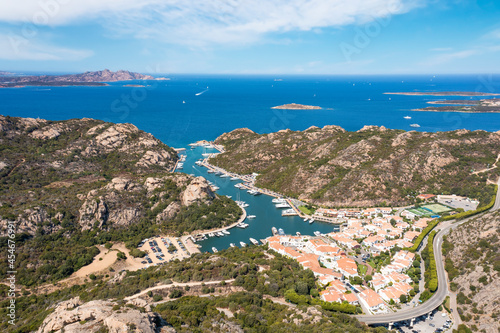 View from above, stunning aerial view of the village of Poltu Quatu with its beautiful harbour full of boats and luxury yachts. Sardinia, Italy.