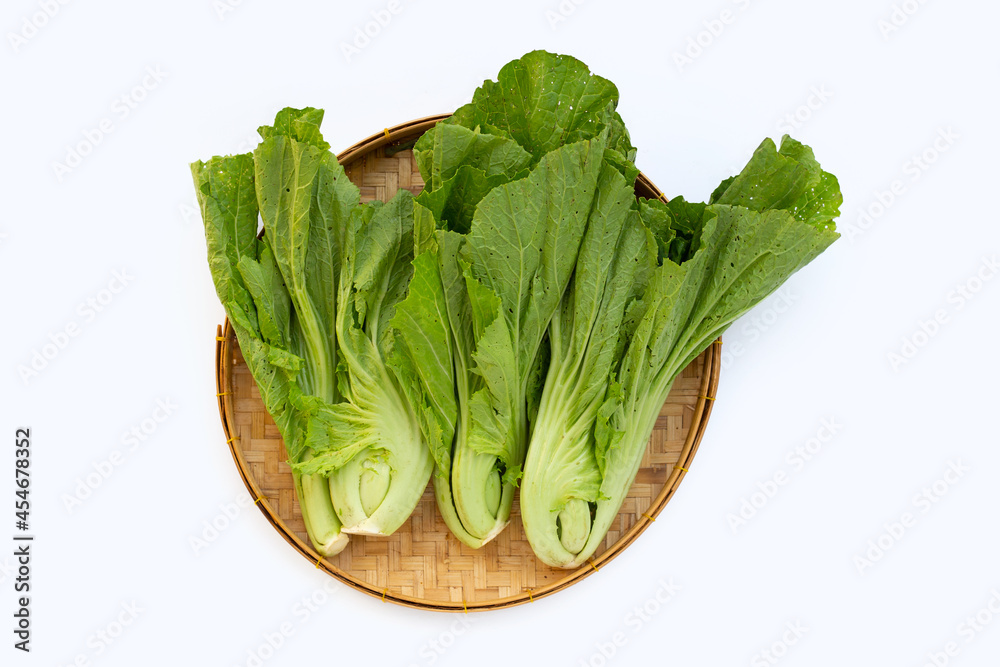 Organic mustard green in bamboo basket on white background. Organic mustard green in bamboo basket on white background.