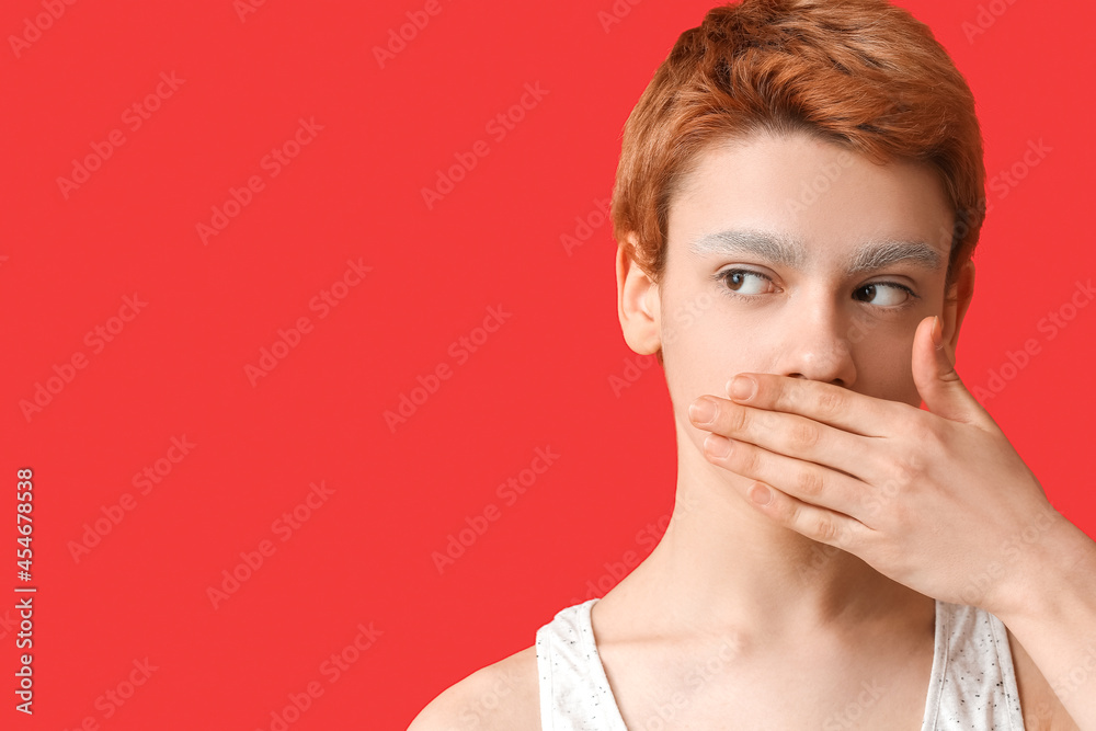 Teenage boy with dyed eyebrows on color background