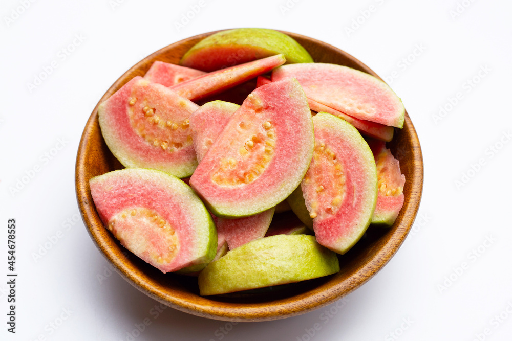 Fresh pink guava in wooden bowl on white background. Fresh pink guava in wooden bowl on white background.