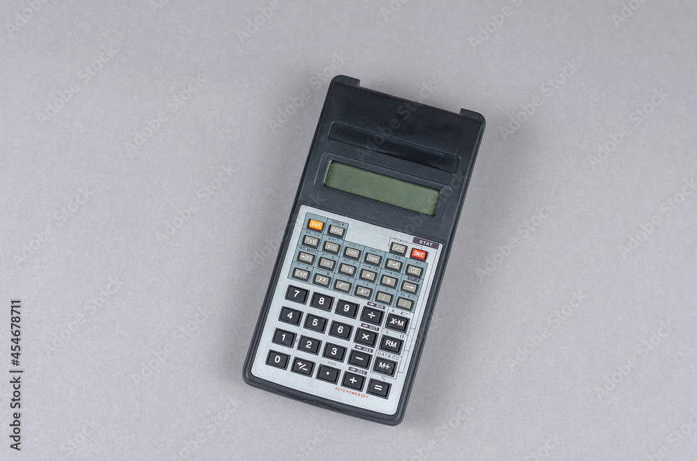 Scientific Calculator against gray background. An electronic computing device for performing operations on numbers or algebraic formulas. Scientific Calculator against gray background. An electronic computing device for performing operations on numbers or algebraic formulas.