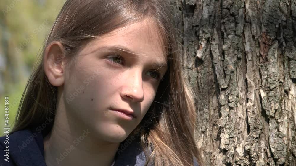 Sad Thoughtful Child by Tree, Unhappy Kid, Depressed Teenager Girl Not Playing, Depression of Adolescents in Coronavirus Pandemic Sad Thoughtful Child by Tree, Unhappy Kid, Depressed Teenager Girl Not Playing, Depression of Adolescents in Coronavirus Pandemic