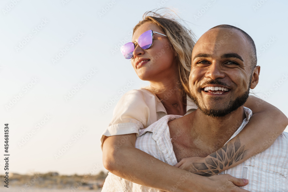 Young happy couple on seashore enjoying the sea Young happy couple on seashore enjoying the sea