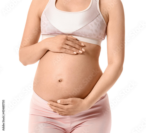 Young pregnant woman on white background