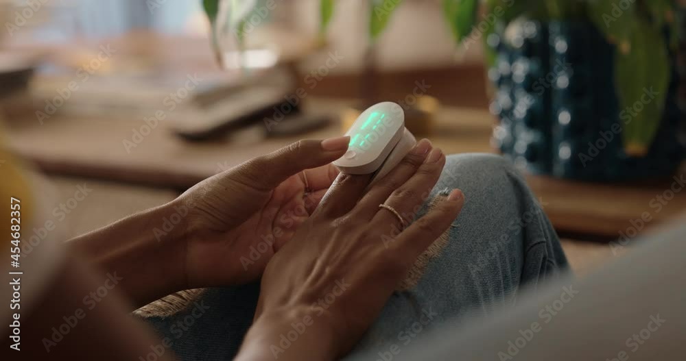 woman using pulse oximeter measuring heart rate pulse monitoring heartbeat with smartphone app at home health care medical technology