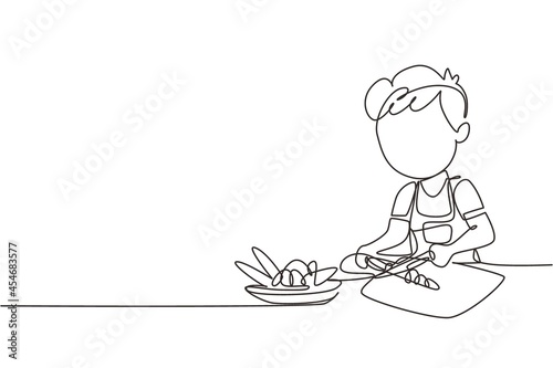 Single one line drawing little girl is cutting carrot and other fresh vegetables. Smiling child is enjoying cooking at home to help mother. Continuous line draw design graphic vector illustration