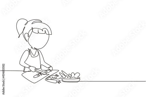 Single continuous line drawing little girl is cutting carrot and other fresh vegetables. Smiling child is enjoying cooking at home to help mother. One line draw graphic design vector illustration