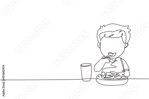 Single one line drawing boy eating healthy morning breakfast food. Happy child eat delicious food with milk at home. School boy enjoying dish. Continuous line draw design graphic vector illustration