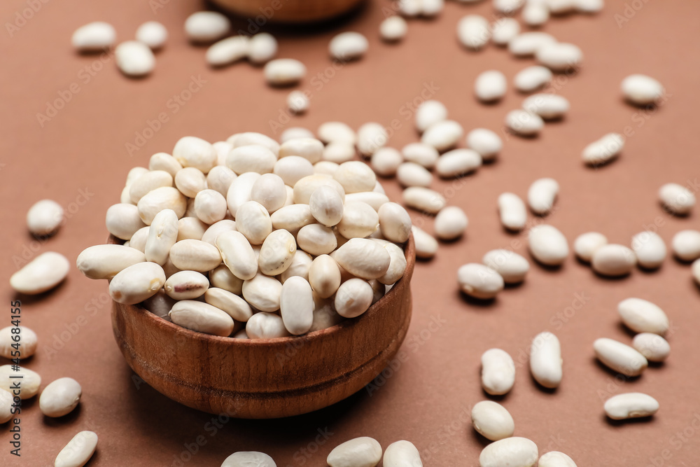 Bowl with raw beans on color background Bowl with raw beans on color background