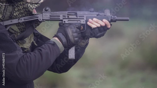 COMANDO SHOOTING A UZI MACHINE GUN photo