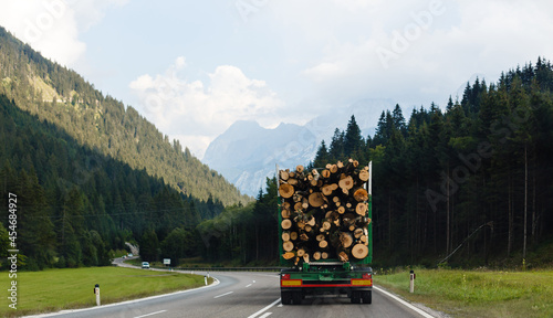 A large truck transporting wood on a mountain road photo