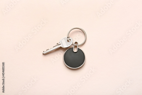 Key with stylish keychain on light background photo