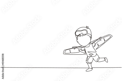 Single one line drawing happy kid boy play toy plane cardboard. Children playing toy plane cardboard, little cute kid in an astronaut costume. Continuous line draw design graphic vector illustration