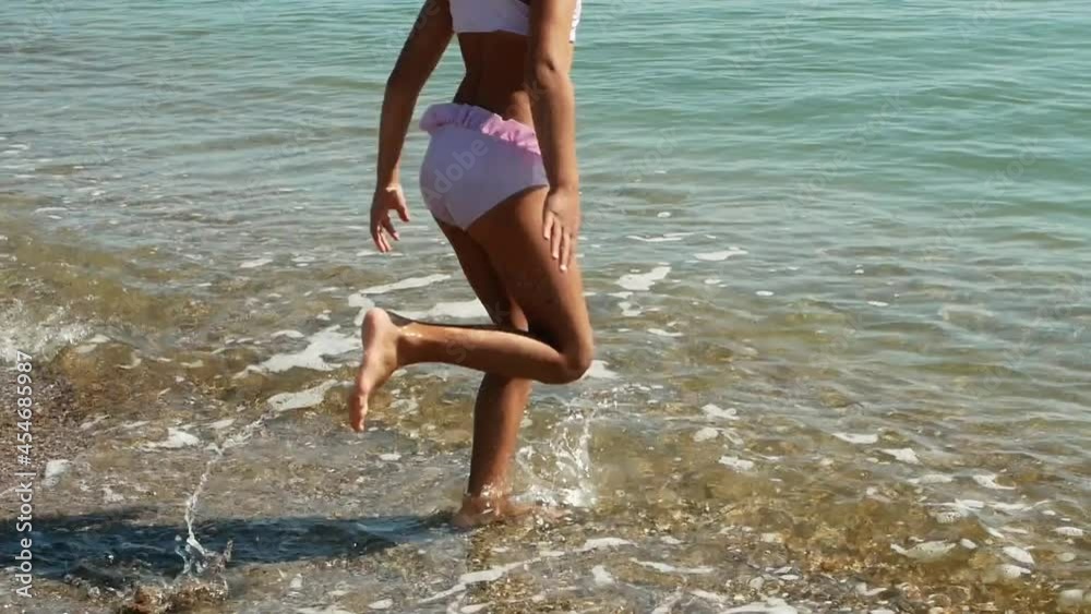 A little girl runs into the seawater of the ocean to swim. Summer vacations, vacations, family travel to warm countries.
A little girl runs into the seawater of the ocean to swim. Summer vacations, vacations, family travel to warm countries.