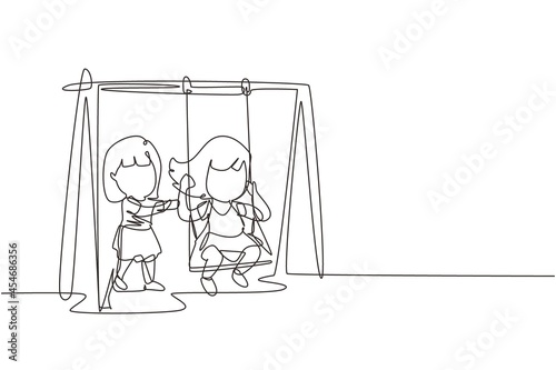 Single continuous line drawing little girl swinging on swing and her friend helped push from behind. Kids playing swing together in public park playground. One line graphic design vector illustration