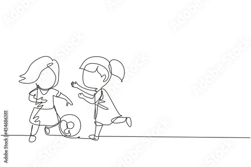 Continuous one line drawing girls playing football together. Two happy little kids playing sport at playground. Smiling children kicking ball by foot between them. Single line design vector graphic