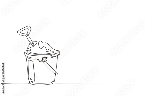 Single one line drawing Bucket and spade. Sand in bucket with shovel. Summer plastic kid toy. Sand bucket and shovel. Children's toys on beach. Continuous line draw design graphic vector illustration