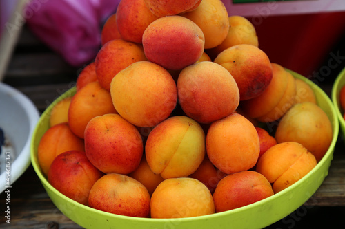 Apricots on the local farm market, eco fruits, juicy products. Shopping organic season products. Healthy grocery. Fruits with waterdrops