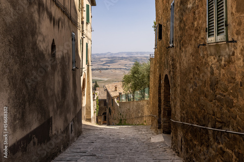 Wallpaper Mural An ancient and narrow sloping alley provides a glimpse on the surrounding Tuscanian landscape Torontodigital.ca