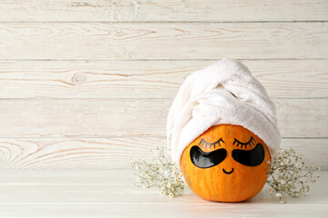Spa concept with pumpkin on white wooden table